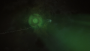 John Stewart Flying In Front Of The Green Lantern Symbol.